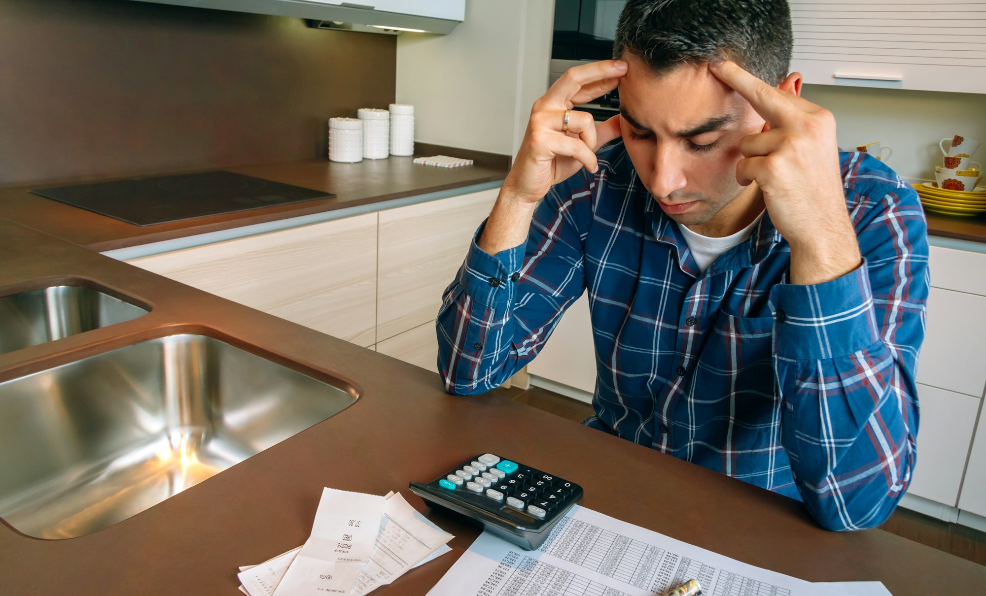 Young man checking bills